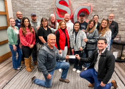 BRN Group of members pose in front of South Central Industries signage.