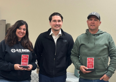 Becky Webb, Troy Officer, and Jeff Garcia holding awards and posing for a picture.