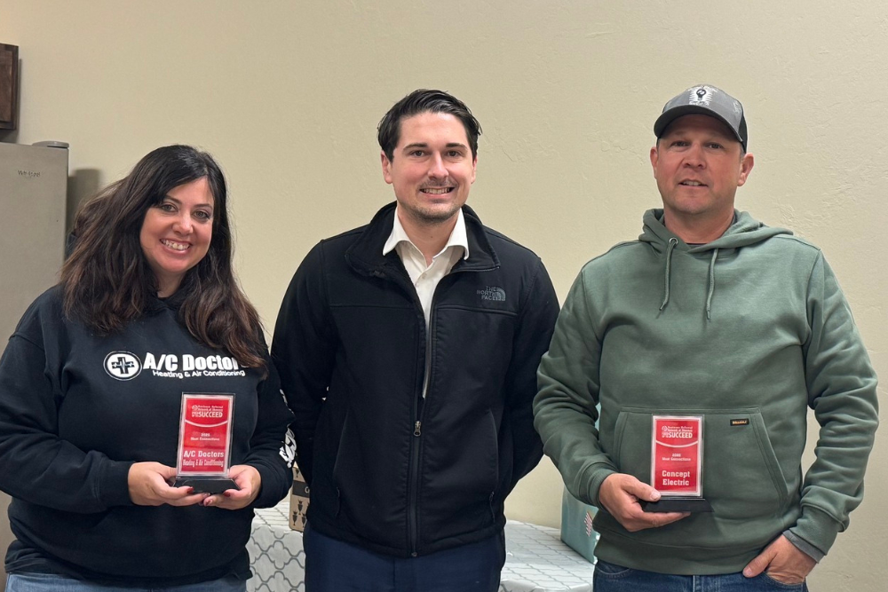 Becky Troy Jeff Becky Webb, Troy Officer, and Jeff Garcia holding awards and posing for a picture.