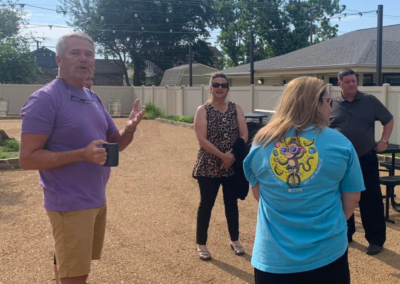 Jimmy, Crystal, Todd, and another person standing outside visiting.