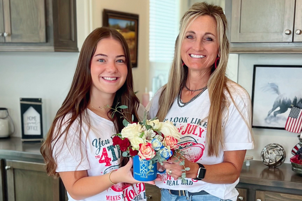 StrideMortgage Amy Moon and assistant Patton pose with a cup of flowers from Stuart & Clover.
