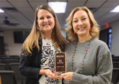 Julie Hokit presents Crystal Wagoner with an award.