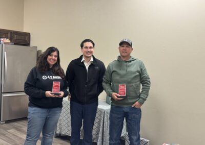 Troy officer hands Becky Webb and Jeff Garcia their awards