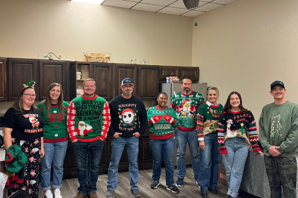 Part of the group of BRN members wearing ugly Christmas sweaters waiting in line to be judged by their sweater for the ugly sweater competition.